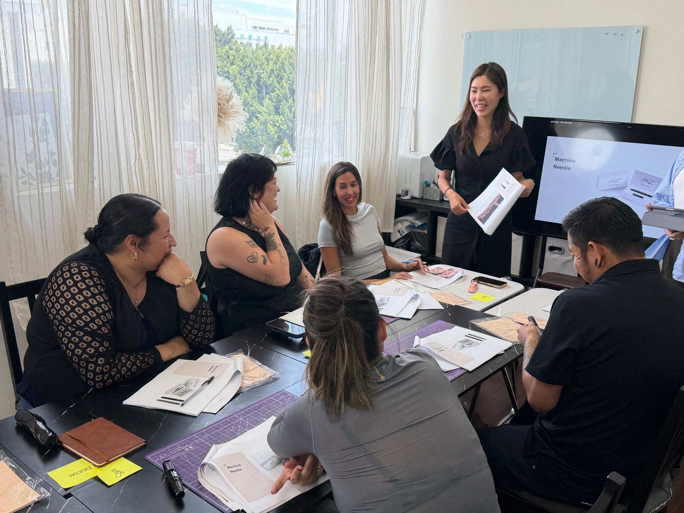 Yu-Jin Lee teaching lip blush theory to a small Master Class cohort at Perfect Line Academy